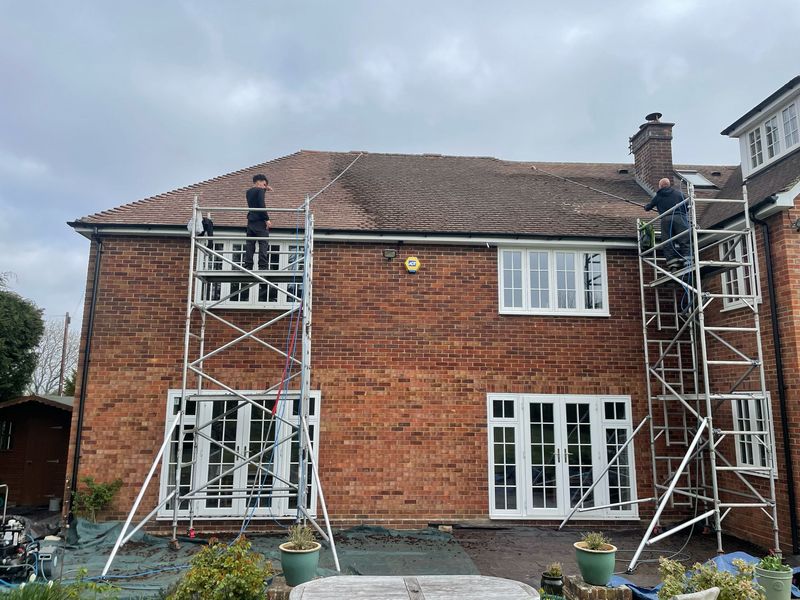 Roof cleaning carried out safely from scaffold towers by The Roof Moss Cleaners in Raunds